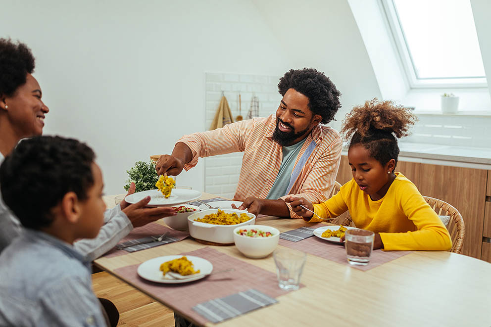 Family of four bonding over a meal.